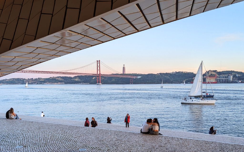 Looking at the Tejo Tagus River from the MAAT gallery at a sailboat and the bridge