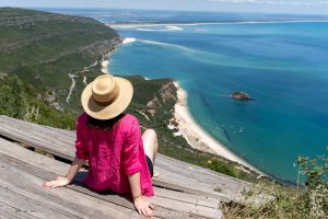 Daniela looking down at Praia do Creiro in Arrábida Natural Park