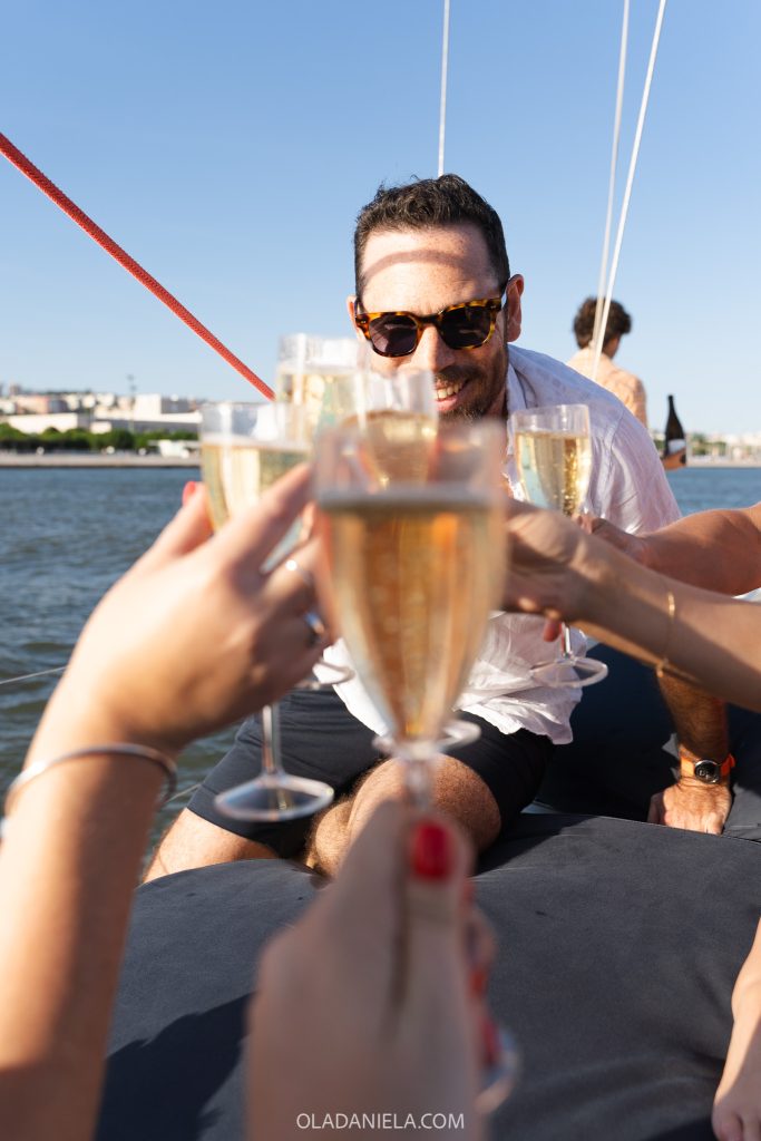 Clinking champagne on a boat in Lisbon