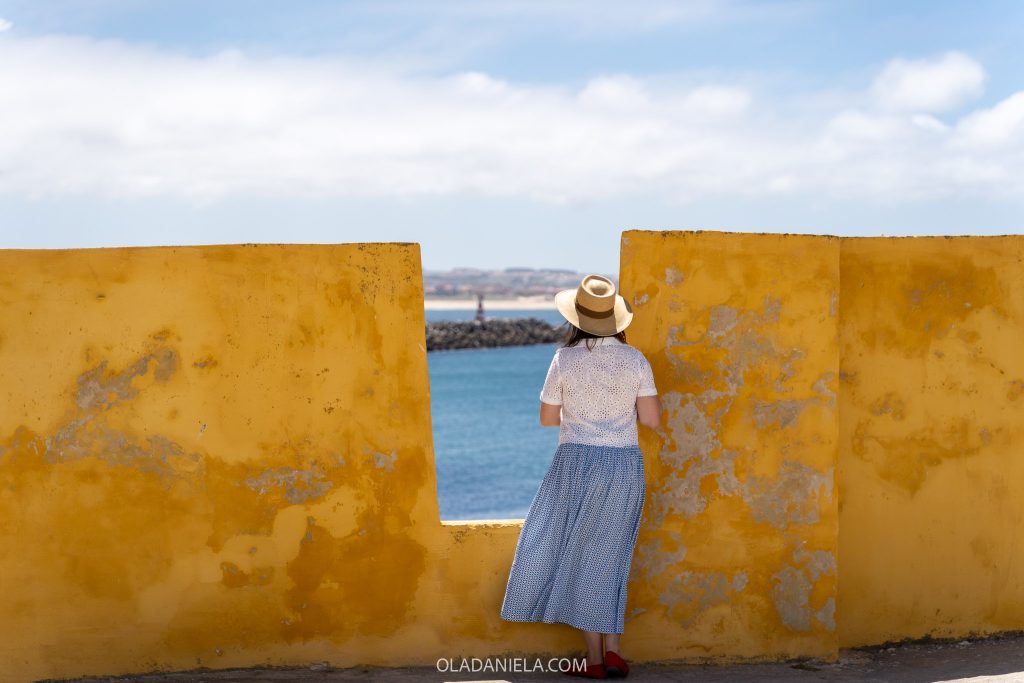 Daniela standing inside the Peniche fort looking out to the ocean