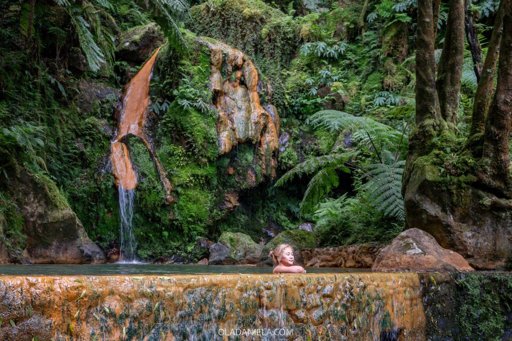 Woman soaking in the Caldeira Velha thermal springs on São Miguel, Azores